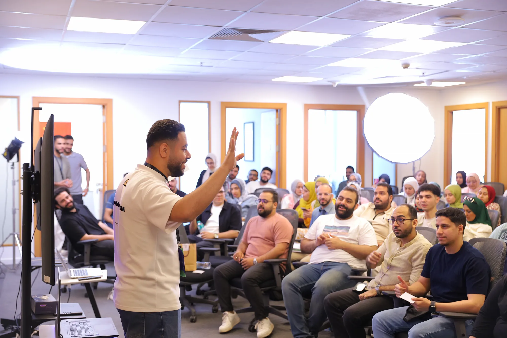 Mohamed Yasser hosting in front of a full room