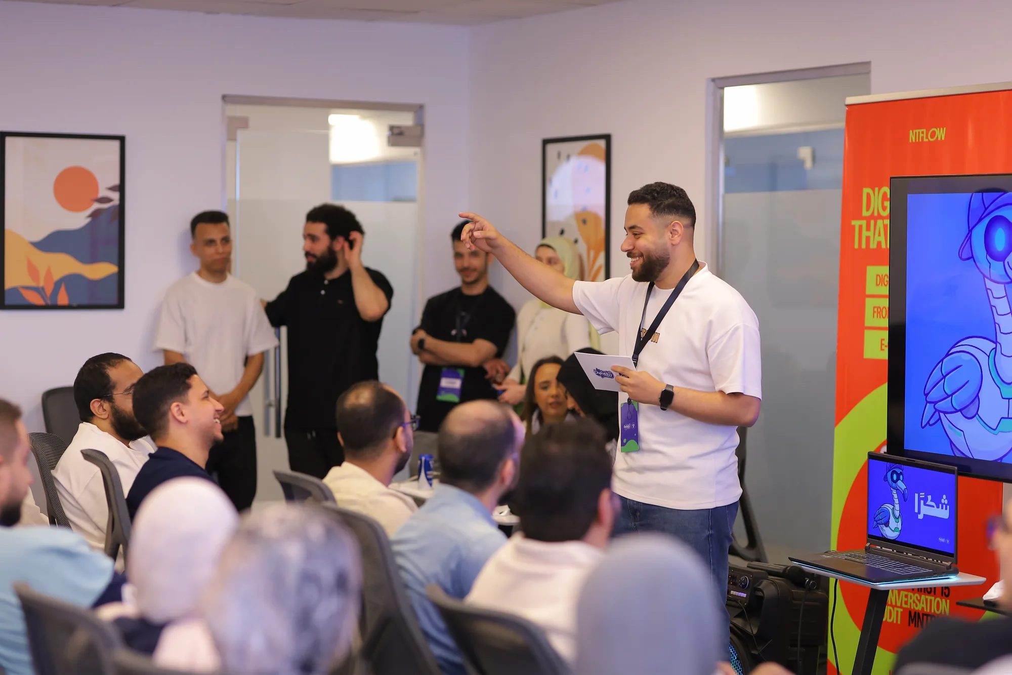 Mohamed Yasser presenting and laughing with the audience